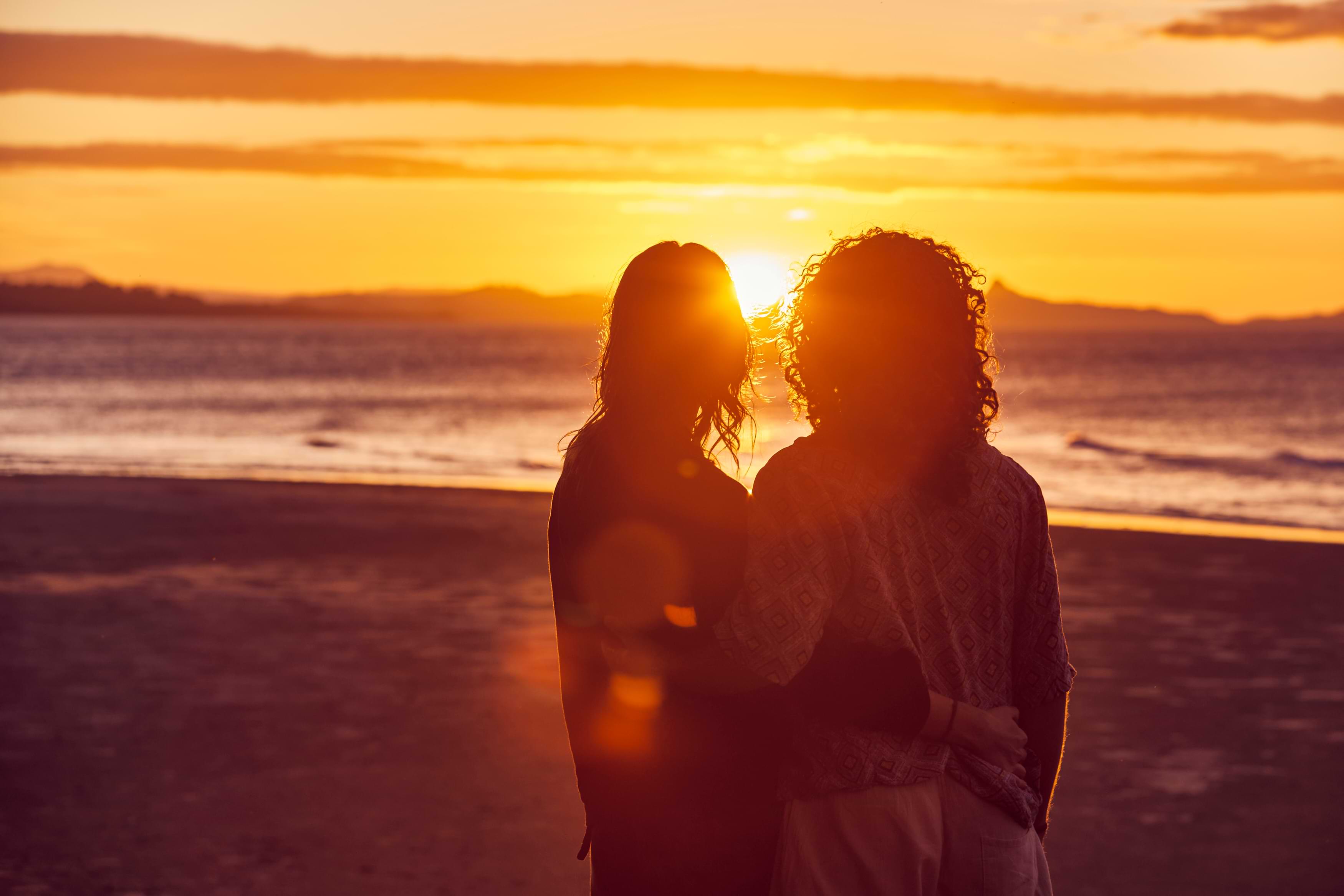 People on beach during sunset